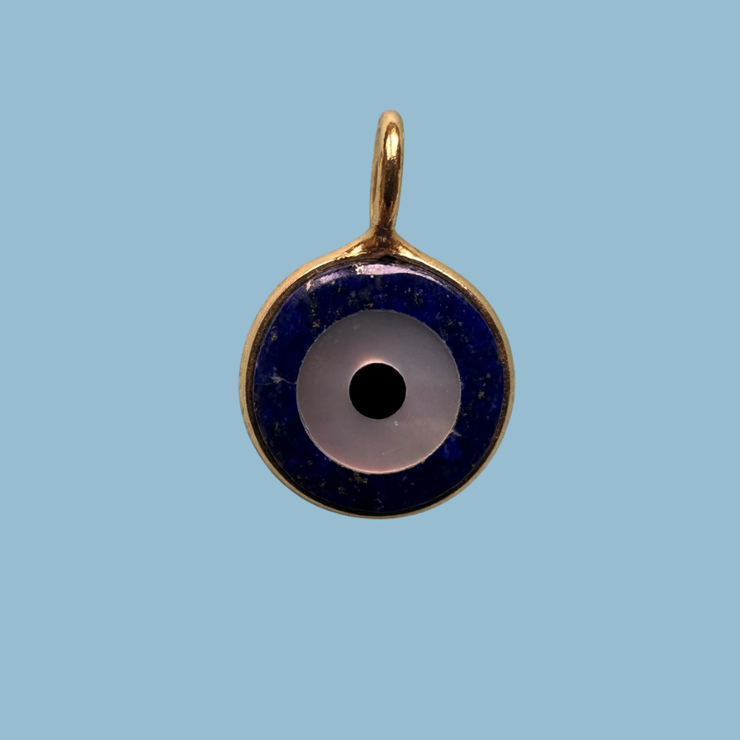 Lapis lazuli evil eye charm in a polished gold bezel with a deep indigo field - Saint Violet Co